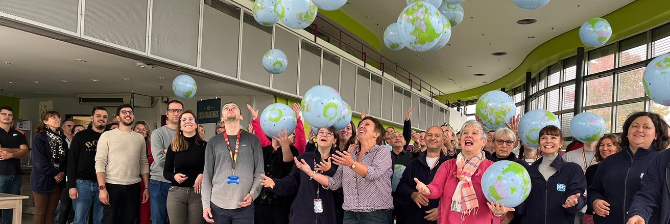 PPG employees throwing globes into the air whilst planning for the future