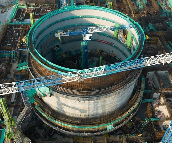 A large circular structure with a blue crane