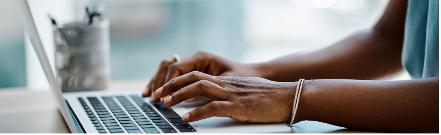 Womens hands typing on keyboard 