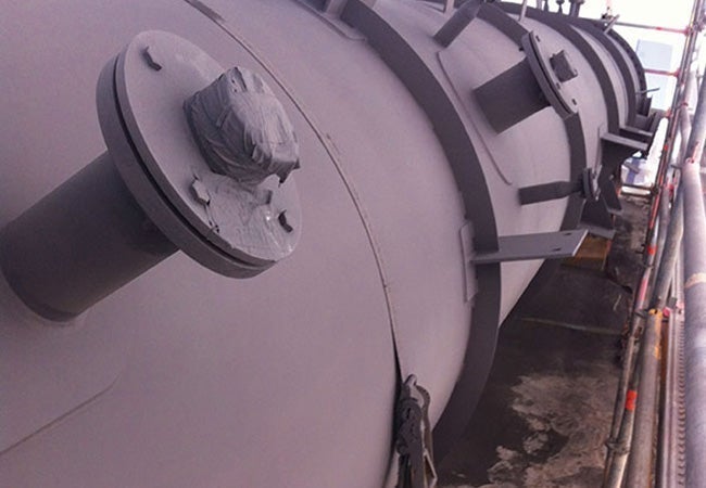 A large grey tank with bolts