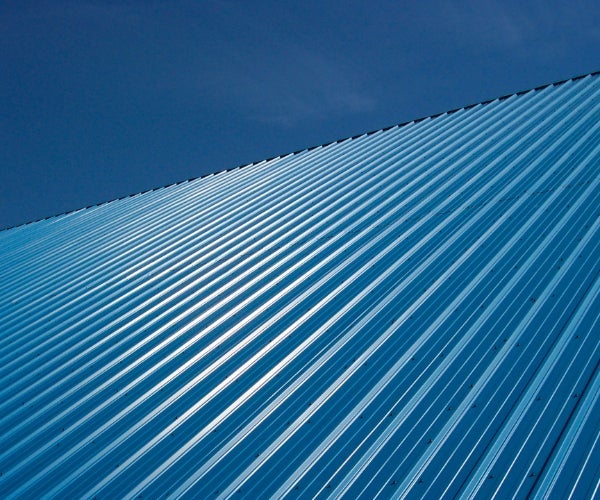 Blue coil metallic roofing system against a blue sky