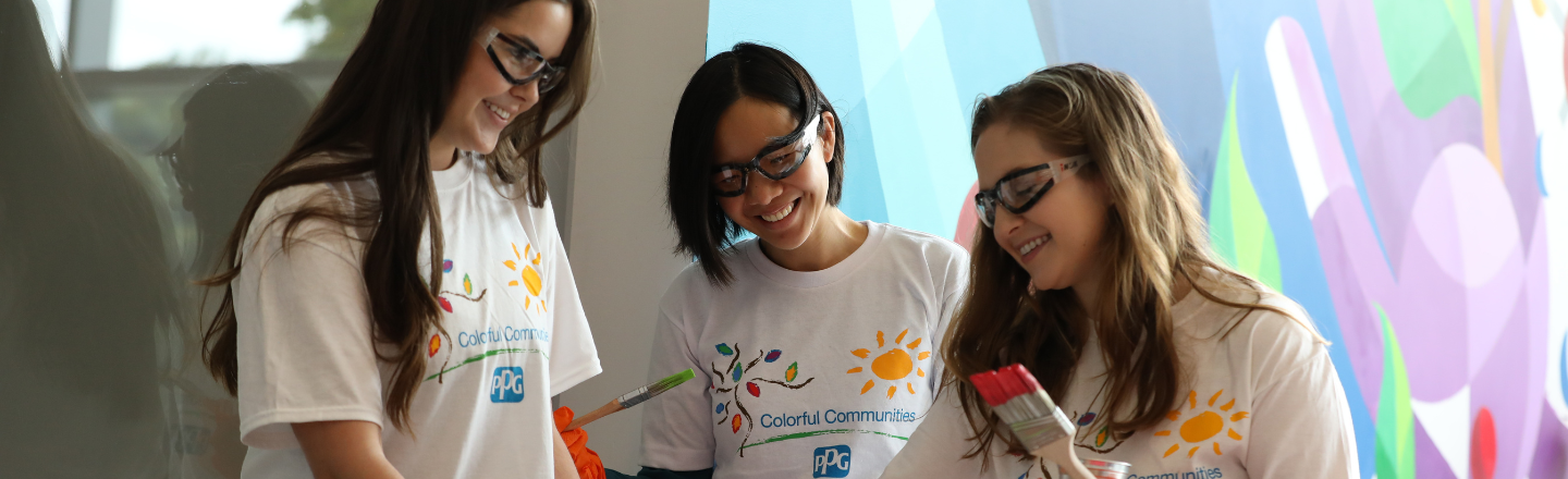 three volunteers painting 