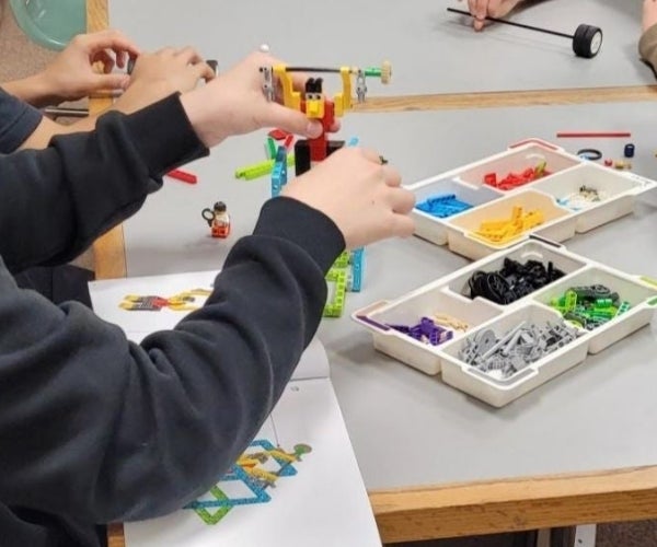 A group of people playing with legos