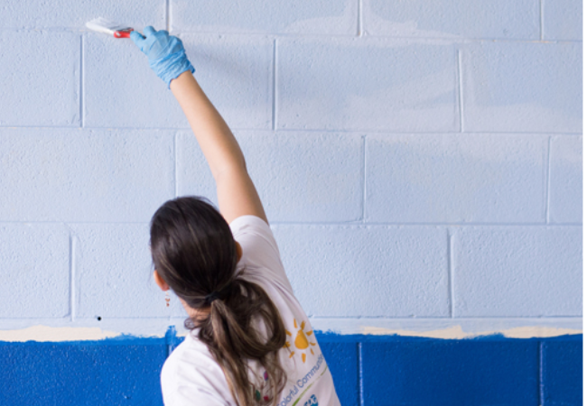 Volunteer in Sumare, Sao Paulo painting wall Lavendar 