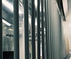 Hung metal components being sprayed on a pretreatment line