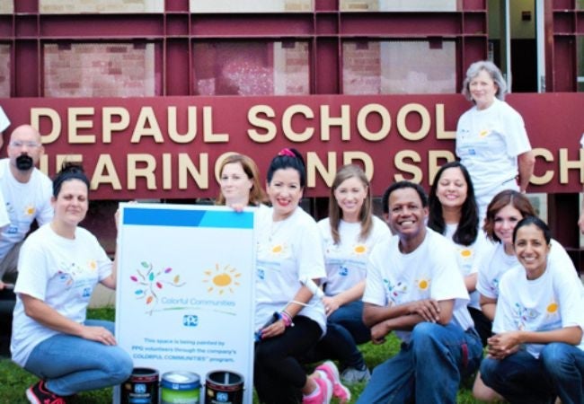 volunteer group holding sign