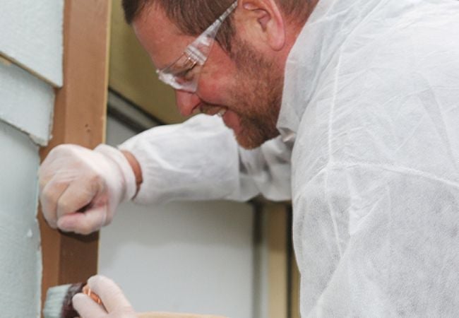 Man painting interior wall