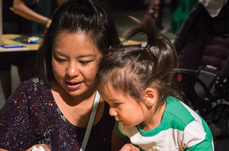 woman and child playing with Legos