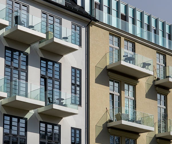 Buildings made up of individual apartments with glass balconies and metal framed windows