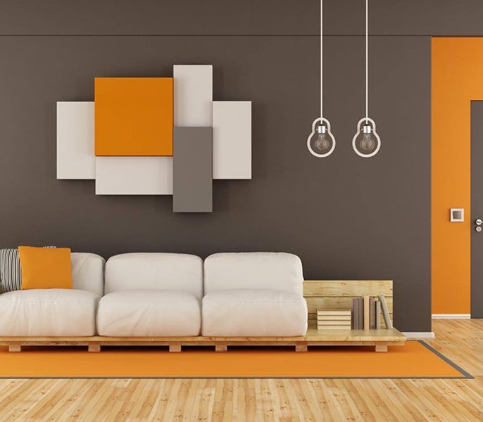 A white couch in a room with orange doors