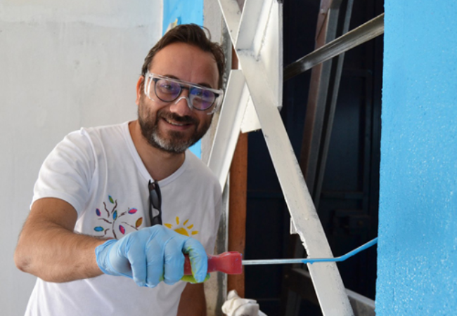 man painting wall blue 