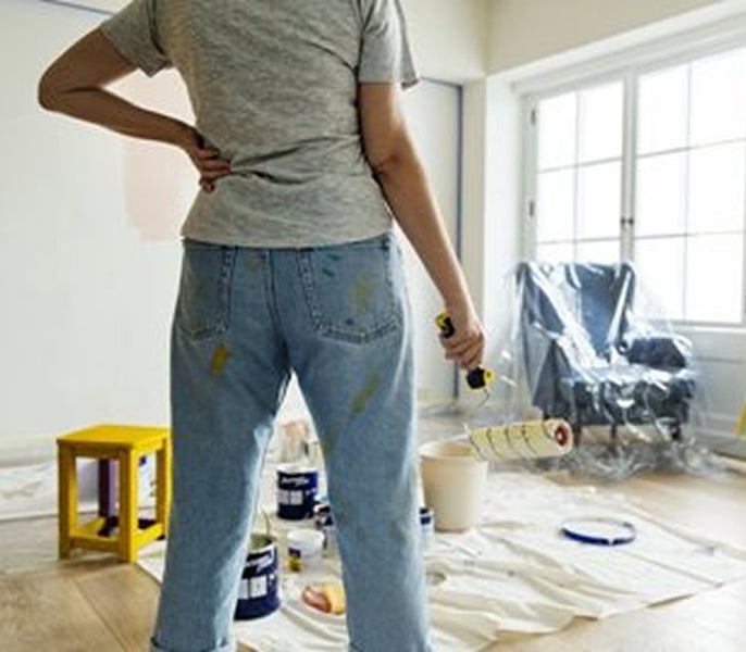 A person holding a paint roller