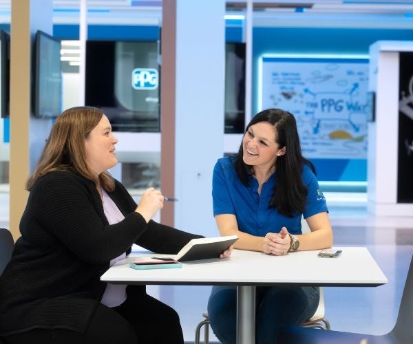 Two women talking at PPG