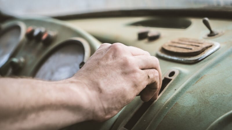 Photo by Danique Photography on Unsplash, a hand on a dashboard