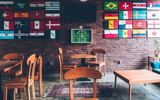 Different country flag clocks on the wall showing the different times