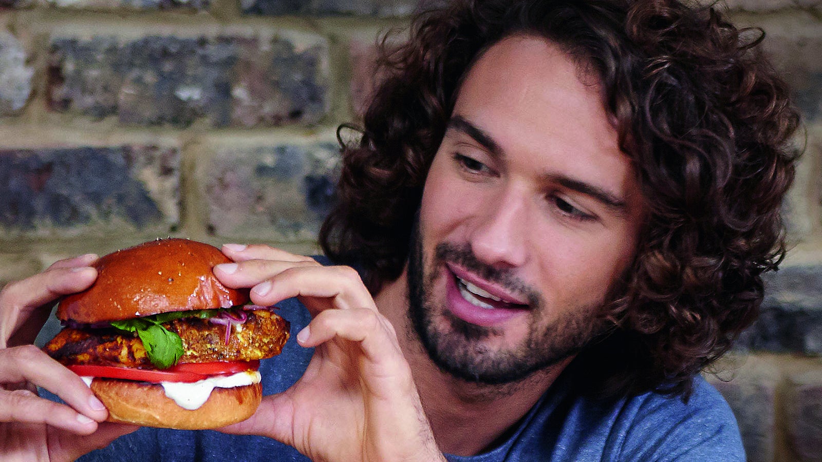 Photograph of Joe Wicks holding a Hamburger