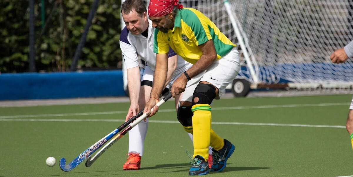 Adult males playing hockey at the England Hockey Championships