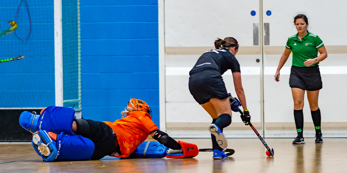 Womens Indoor Hockey, Goalie trying to save shot