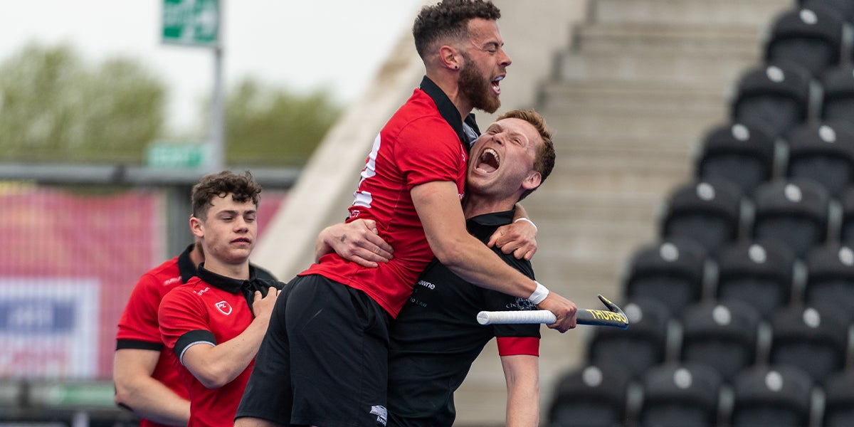 Male players celebrate winning at the England Hockey League Finals