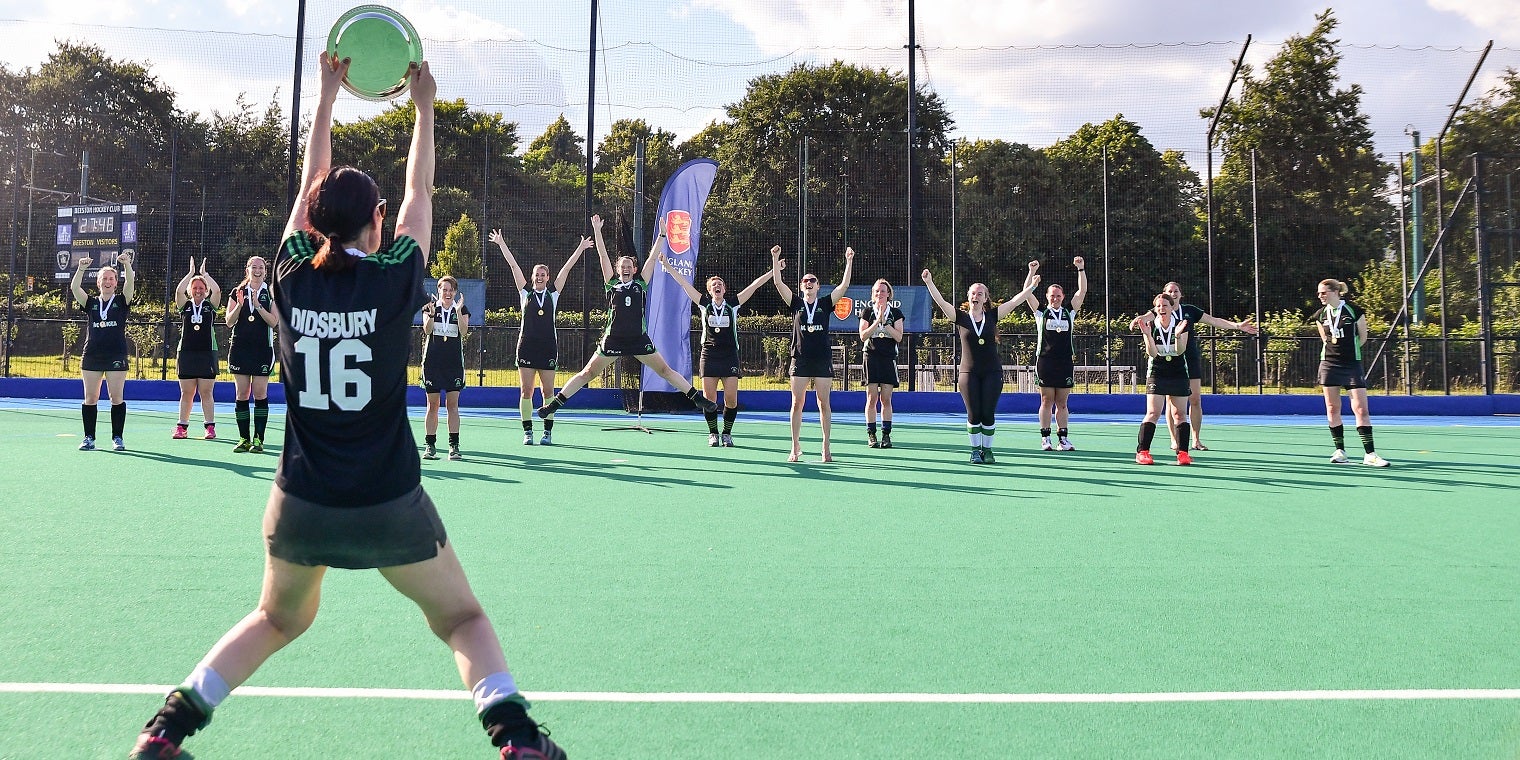 Female players celebrating plate competition win 