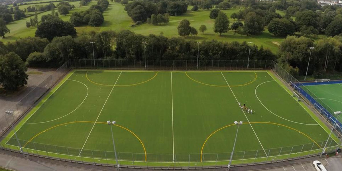 Timperley hockey pitch - Green Pitch in surrounded by trees 