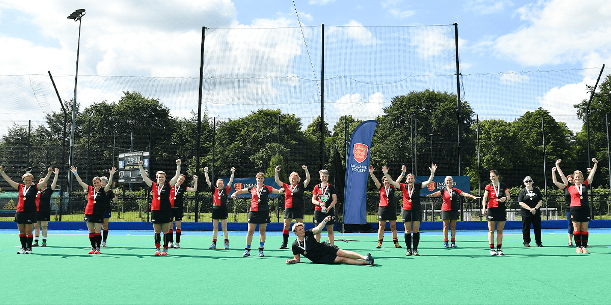 female masters players celebrating cup win