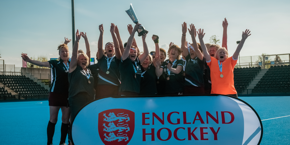 Masters Hockey Players Celebrating Competition win with Trophy lift