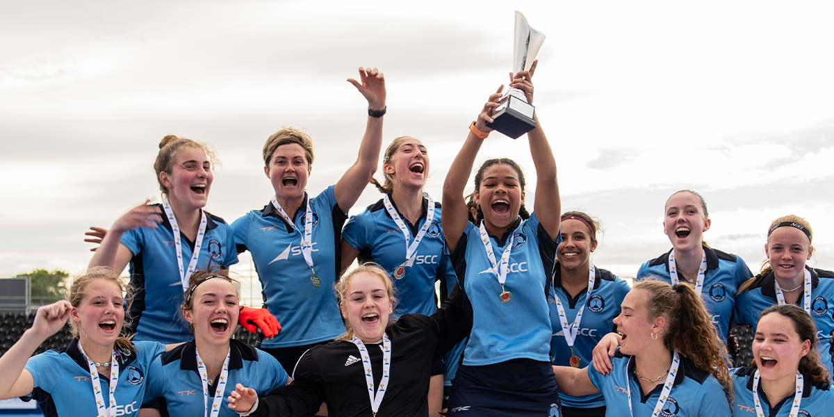 female players celebrating with trophy