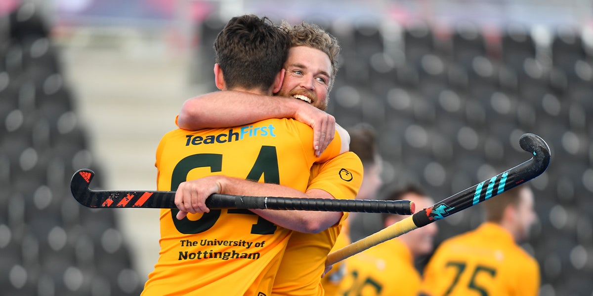males hugging at the England Hockey Championships