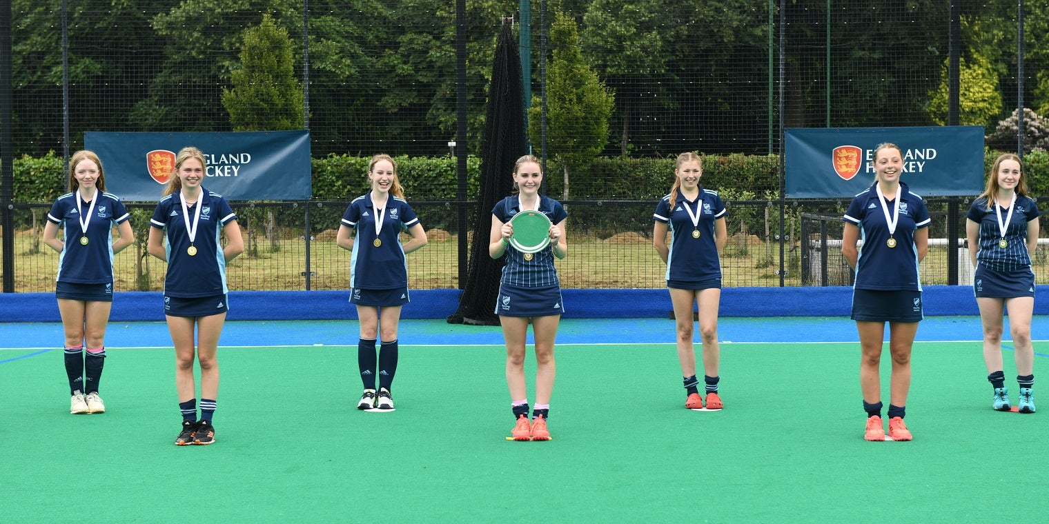 Female players celebrating plate competition win 