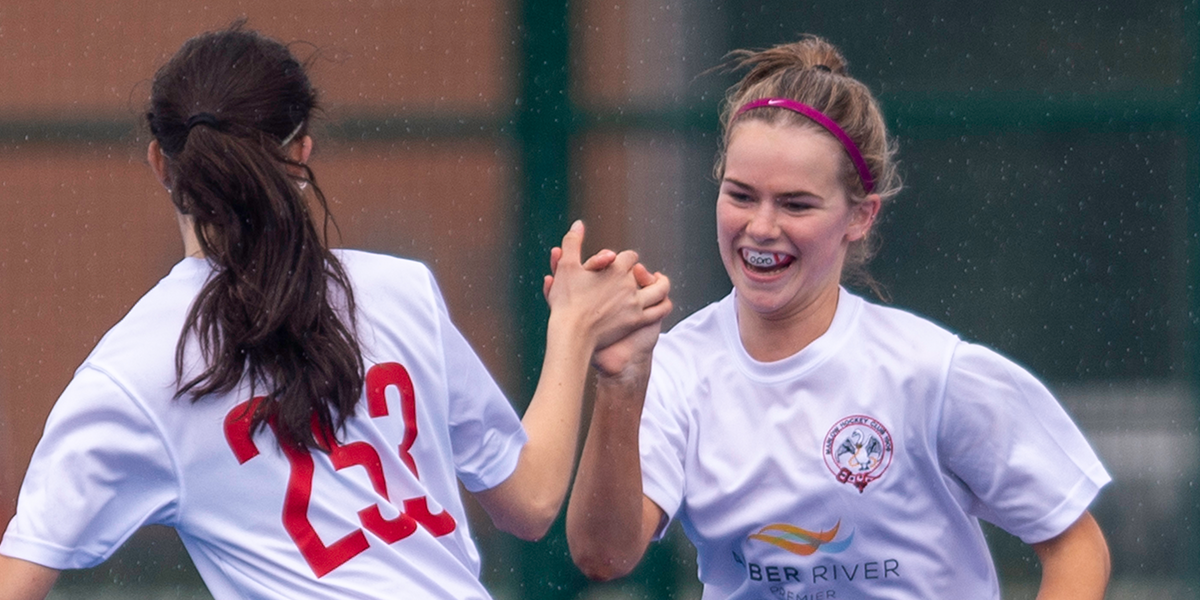 Female Hockey Players Celebrating Goal