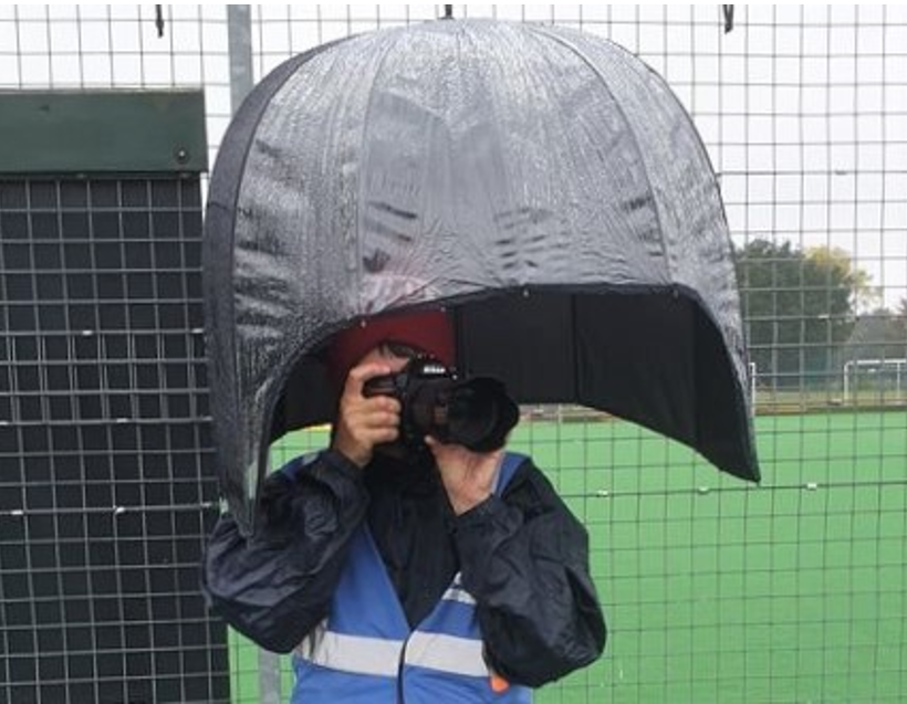 Me%20photographing%20matches%20in%20the%20rain - England: International Women's Day - Jean Fitch's lifelong love of hockey - The theme of the 2025 International Women's Day is Accelerate Action. Jean Fitch from Bedford Hockey Club has spent the last 30 years involved in the club and was integral to the launch of the successful walking hockey sessions while playing in goal and fundraising for the club. We invited her to share her love of hockey and the positive changes that have been made at the club and the sport.  