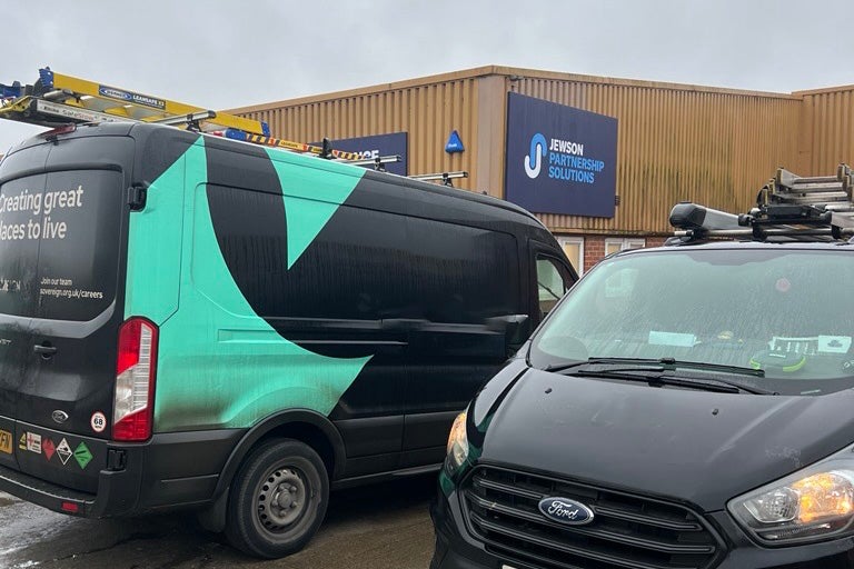 Two SNG vans parked outside a Jewson trade store.