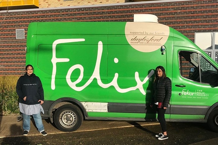 SNG customer Gule Hanid with volunteer from The Felix Project in front of food van.