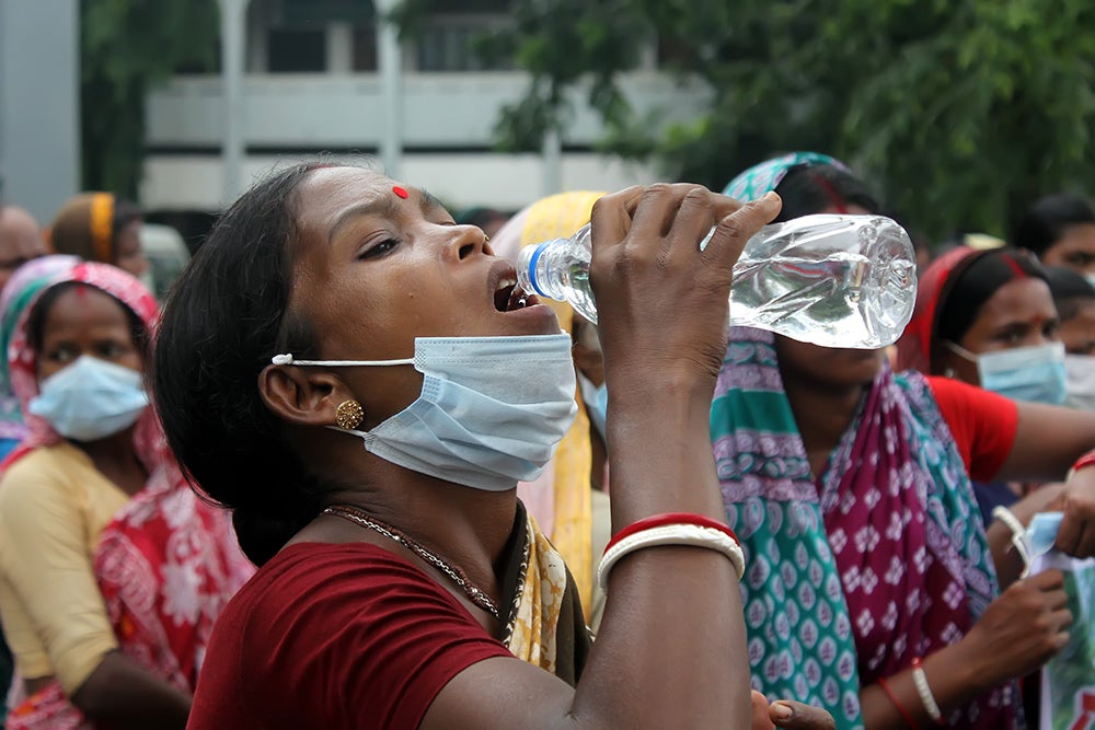 Woman drinking bottled water. Credit: Shutterstock.