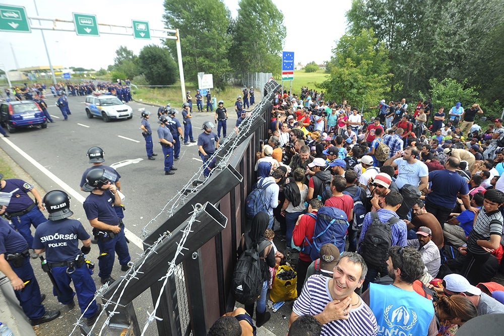 Migrants at a border. Credit: Shutterstock.