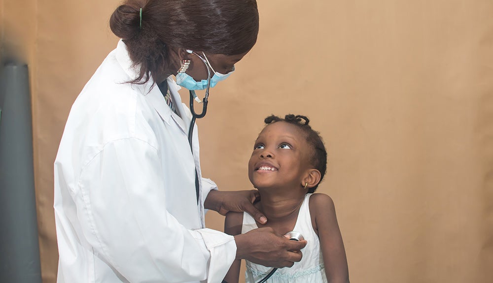 African woman doctor and child. Credit: Shutterstock.