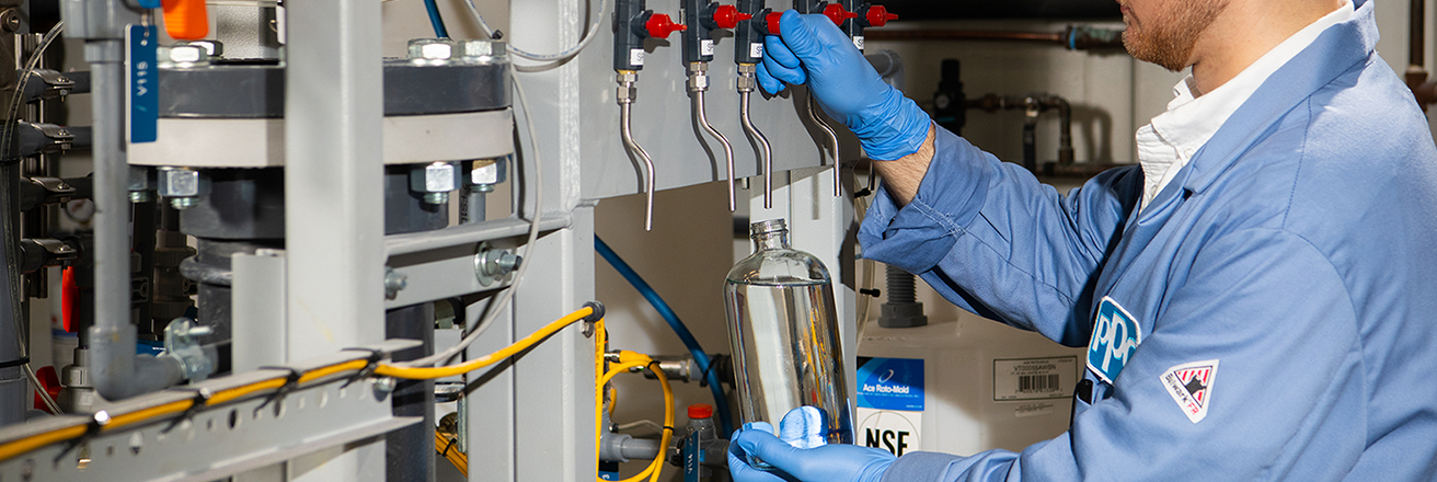 PPG employee working on a machine in lab