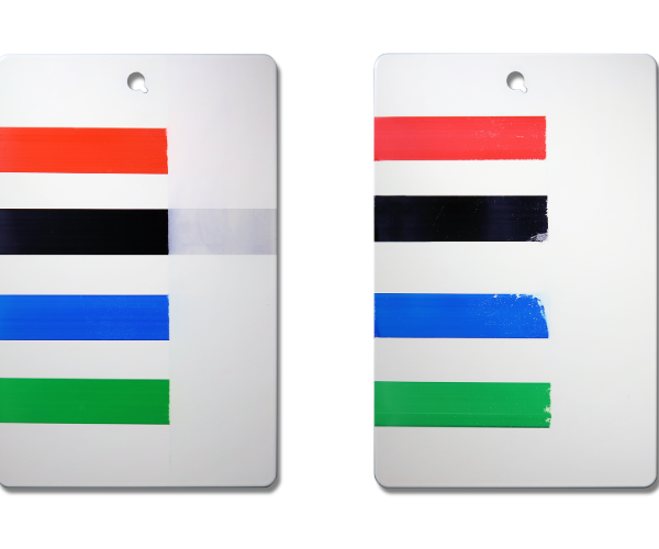 Lines of red, black, blue and green paint on silver sample panels