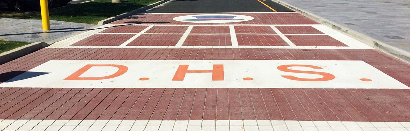 A crosswalk with a marking that says D.H.S.