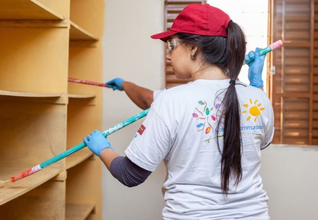 woman painting shelves