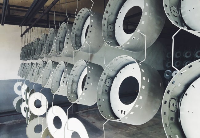 Round metal drums hung to dry