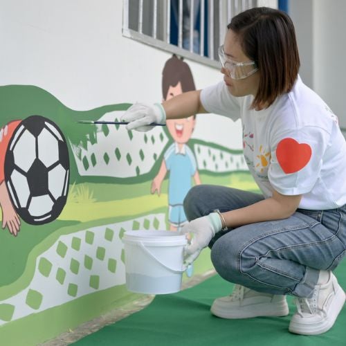 woman painting mural