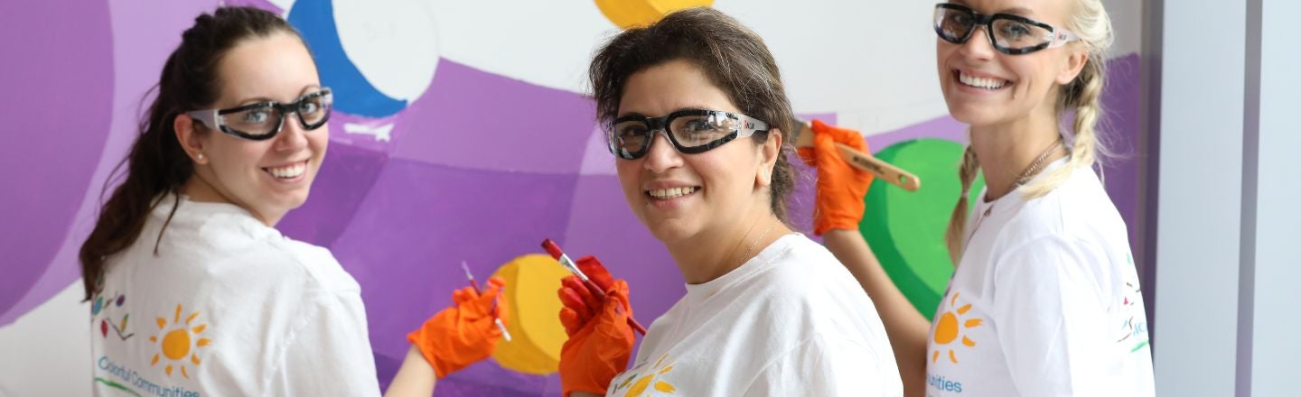 three volunteers painting