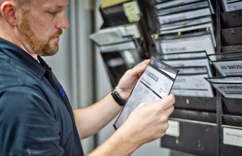 Worker inspecting documentation