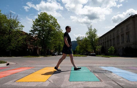 KC Greenly, center, places a red color panel as Seth Haagan, left, Jerry, right, and other workers help with the reconstruction of Missoula's downtown rainbow crosswalk at the intersection of East Pine Street and North Pattee Street on Wednesday. The group of contractors said they were hired by a private group not affiliated with the city to remodel the colorful crosswalk after numerous years of wear and tear. The workers said the private group gathers funds to reconstruct the crosswalk every three years.