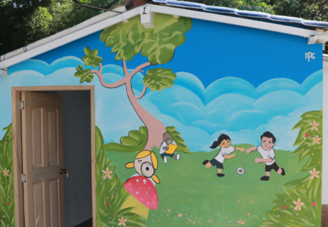 Painted mural of children playing soccer 