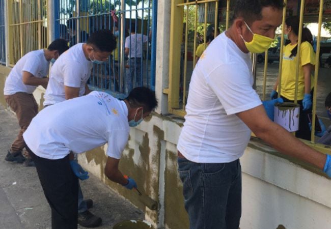 men painting outdoor spaces