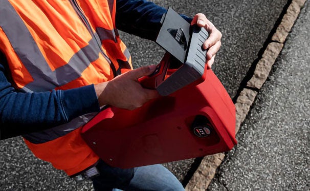 Worker measuring markings on a roadway