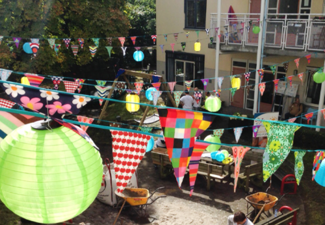 Colorful flags hanging over volunteers in Amsterdam, Netherlands